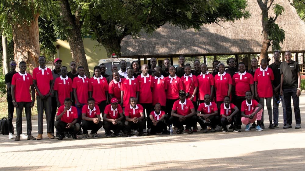 Kakebe Tech Camp participants in red camp shirts during a camp visit